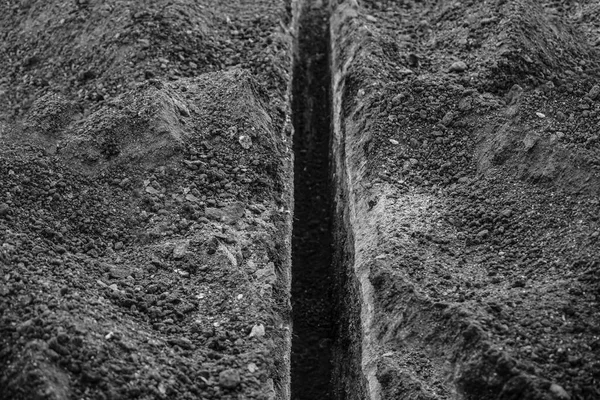 Digging ditches for drainage. A long trench was dug for laying a cable — Stock Image Digging Ditches Drainage Long Trench Dug Laying Cable Stock Photo