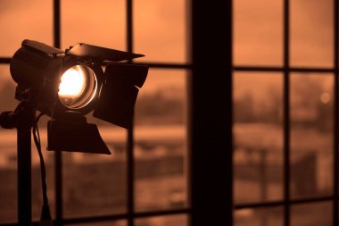Pencere arkasında lambalı bir fotoğraf stüdyosu. Video üretimi için profesyonel ışıklandırma ekipmanları. sabit ışık