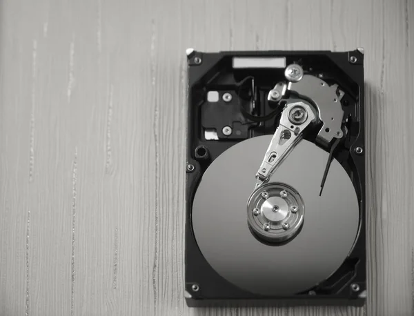 Computer hard disk drive.  hardware disk, memory storage cylinder.  table background. top view.