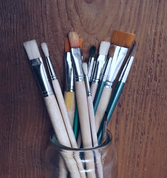 Many Paint Brushes Glasses Jar Isolated Wooden Table Background — Stock Photo, Image