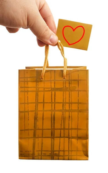 Мужчина Держит Золотой Подарочный Пакет Пустая Бумажная Упаковка Держится Изолированных — стоковое фото