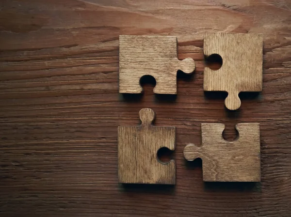 Four Wooden Puzzle Pieces Concept Connection People — Stock Photo, Image