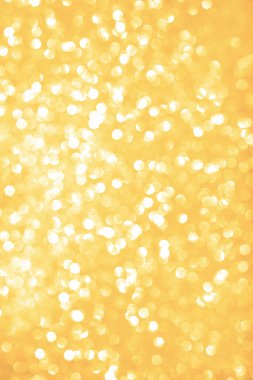 Bokeh altın arka planı. Sarı soyut kar yağışlı kış tatili arkaplanı