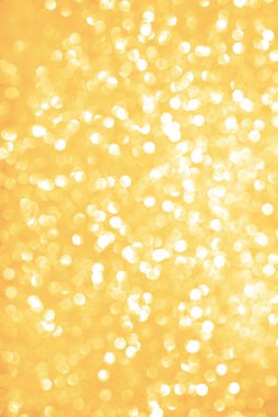 Bokeh altın arka planı. Sarı soyut kar yağışlı kış tatili arkaplanı