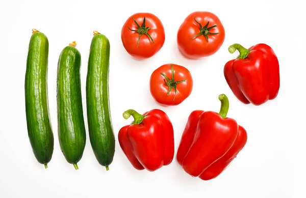Fresh tomatoes, cucumbers and paprika peppers isolated on white background 