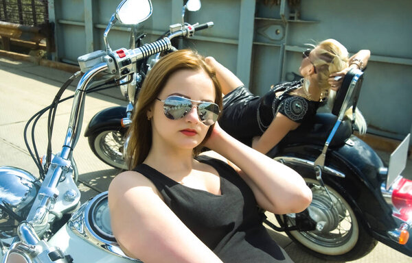 Молодые девушки на вертолётах на фоне металлического моста