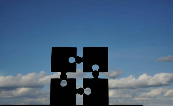 Four Puzzle Piece Blue Cloudy Sky Background — Stock Photo, Image