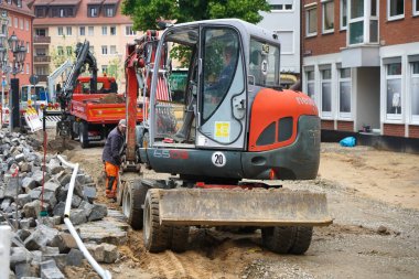 NUREMBERG, GERMANY - Excavator machinery on the street excavation site prepared for reconstruction of historical paving stone