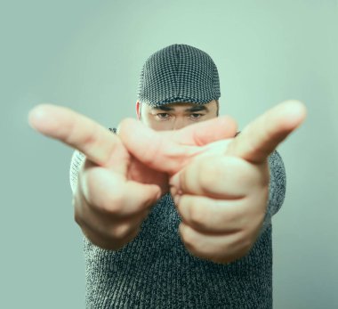 The young man shows the index forefinger.  isolated on white background
