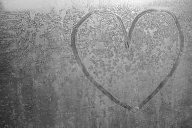 Donmuş bir kış penceresinde çizilmiş bir kalp..