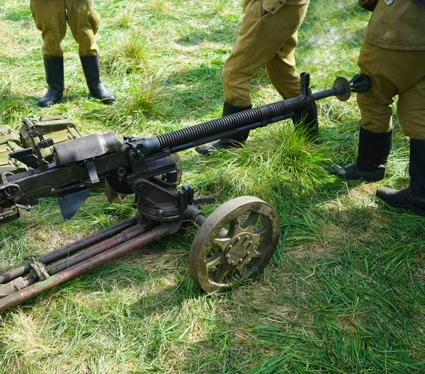 Heavy machine gun. Old Powerful Military machine Gun. long barrel. soldier standing around.