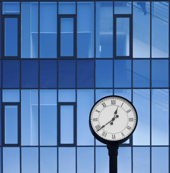 Clock of office building. Modern round clock in the background of brick building. time is money idea.