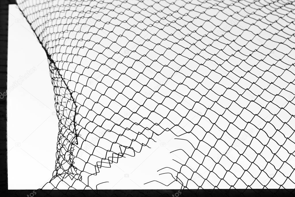 damaged wire mesh on white background. Mesh netting with hole isolated on white background            