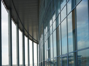 Binanın arka planındaki soyut mavi cam duvar. Ofisin arka planındaki bulanık ofis lobisi. İç mekan boş. Cam duvardan gelen bulanık ışık var. 