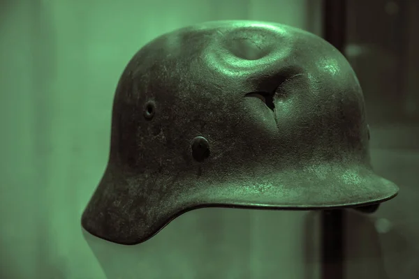 German military helmet with a punched hole from a shrapnel. world war 2