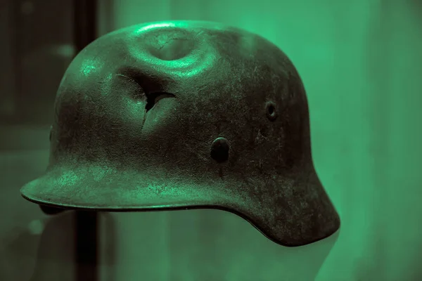 German military helmet with a punched hole from a shrapnel. world war 2