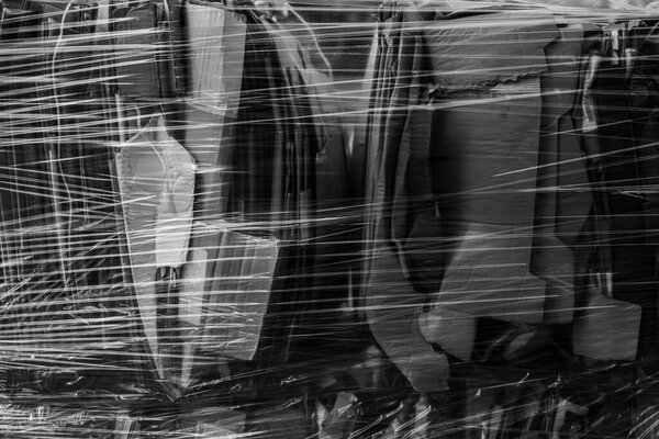 background of folded cartons packed in plastic wrap