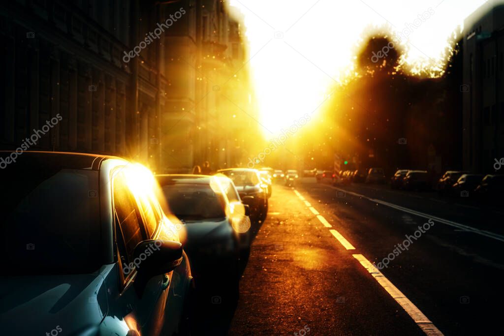 Cars parking on the road in city in early morning. View to the automobiles, parked in the tow