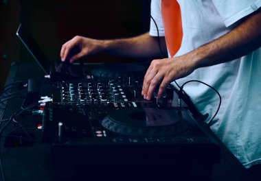 Hip hop DJ 'i kulüpteki partide dijital CD pikaplarda müzik parçalarını eşeliyor. Disk jokeyi müzikholün sahnesinden canlı yayın yapıyor. 