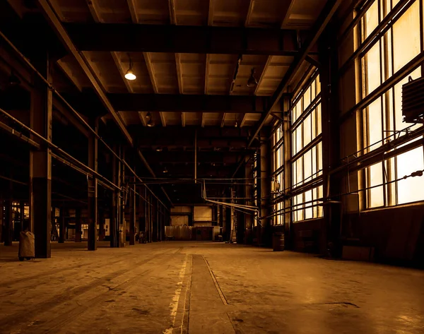 Interior of old abandoned factory hallway with big windows. empty steel structure workshop, interior of abandoned factory buildings or warehouse background