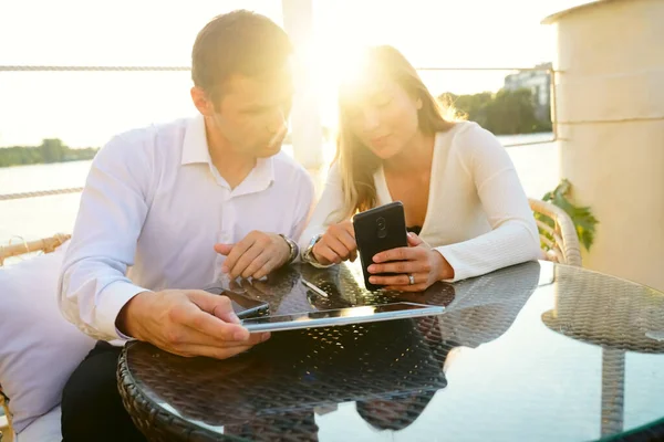 business couple having fun and talking together at the coffee shop. street summer cafe. outdoor shot. Happy man and woman.