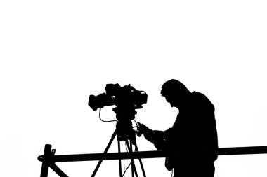 Kameraman 'ın silueti ve üç ayaklı kamerayla izole edilmiş.