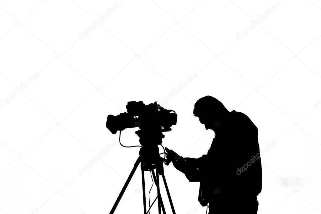 silhouette of Cameraman with professional camera on tripod isolated