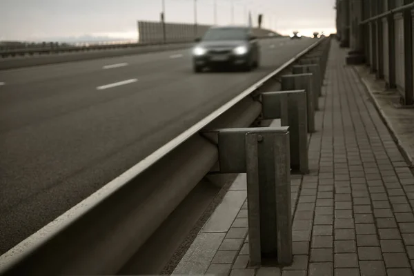 Bridge over the highway. Pedestrian road along the machine bridge. Automobile bridge. blurred car. bump stop.