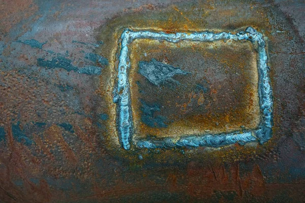 Rusty metal. texture of pipe background with a weld seam. Metal red corrosion. Orange gentle structure of oxidation on welded seam.