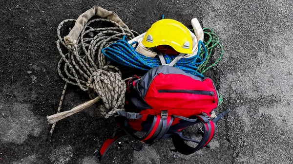 Climbing equipment on asphalt road  background. top view. high-altitude installer