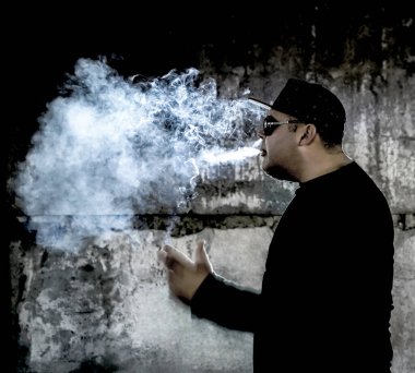 Siyah arka planda sigara içen bir adamın silüeti