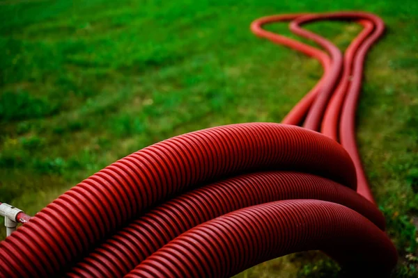 Set Red Corrugated Pipes Green Grass Meadow — Stock Photo, Image