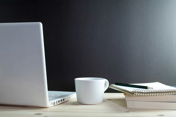 Arbeitsplatz mit Laptop-Kaffee und Buch auf Holztisch. — Stockfoto
