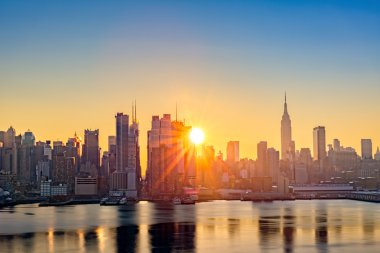 Midtown Manhattan skyline at sunrise clipart