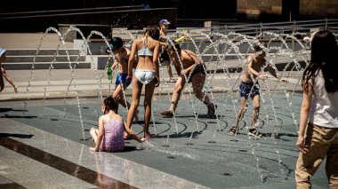 Çocuklar meydandaki çeşmede yıkanıyor..