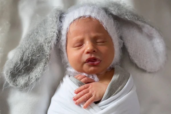 Portrait of a newborn who grimaces in a hat with ears — Stock Photo, Image