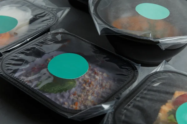 Dietary food in the containers on the concrete background