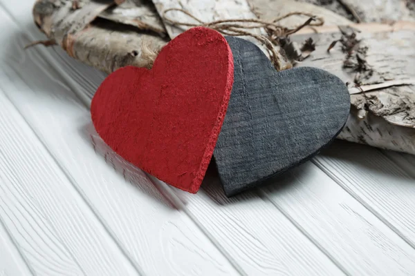 Wooden hearts on white wood background — Stock Photo, Image