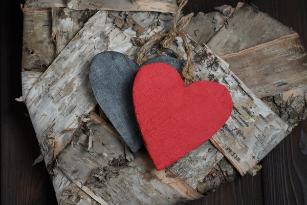 Wooden hearts on dark wood background — Stock Photo, Image