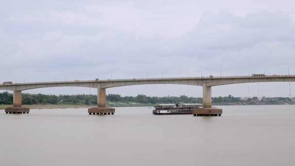 Cruise ship passing under bridge on river — Stock Video