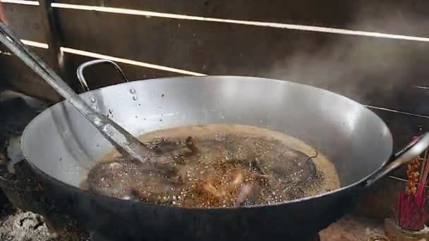 Kleine Schlangen im Wok mit Metallzange frittieren — Stockvideo