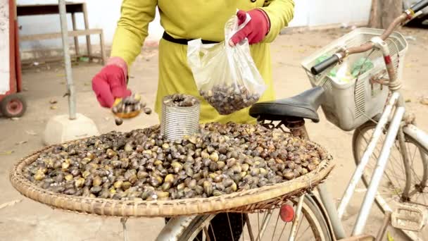 Πωλητή δρόμου αχιβάδα χρησιμοποιώντας καλάθι μπαμπού σταθερά στο πίσω μέρος του ποδηλάτου — Αρχείο Βίντεο
