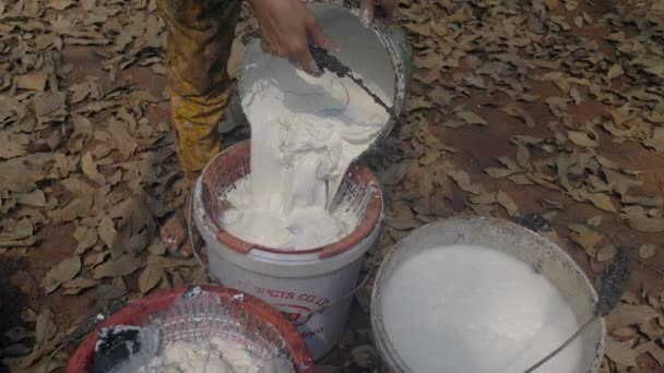Close Farmer Pouring Harvested Latex Bucket Using Plastic Strainer — Wideo stockowe