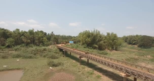 Flying Motorbikes Crossing Old Steel Bridge Small River Low Tide — Stock Video