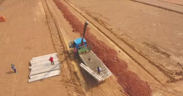 Luftaufnahme Eines Kleinen Lkw Mit Kran Entladesäulen Für Den Hausbau — Stockvideo