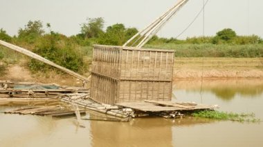 Bambu balık sandık düşük tide nehirde çıkan; Çince Balık ağı arkasında 
