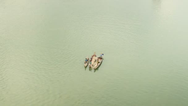 Blick von oben auf kleine Fischerboote auf dem Fluss, die Seite an Seite gepeitscht werden, um ein großes Fischernetz zu benutzen — Stockvideo