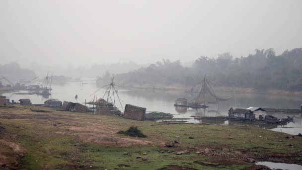 Houseboats e reti da pesca cinesi lungo la riva del fiume nella nebbia del mattino presto — Video Stock