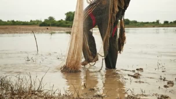 Fisher standing up by the river looking for a good place to cast the net — Stock Video