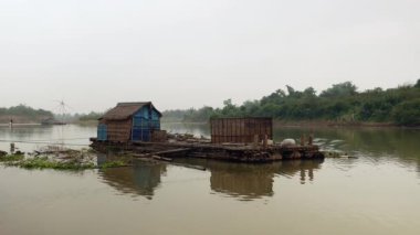 Arka planda bir göl ve Çin balıkçılık ağı üzerinde Houseboat